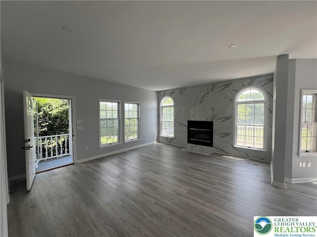 106 Lynx Ln, Chestnuthill Twp, PA 18330 - unfurnished living room with healthy amount of natural light, wood finished floors, and a premium fireplace