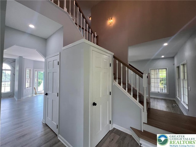 106 Lynx Ln, Chestnuthill Twp, PA 18330 - staircase featuring healthy amount of natural light, wood finished floors, a towering ceiling, recessed lighting, and arched walkways