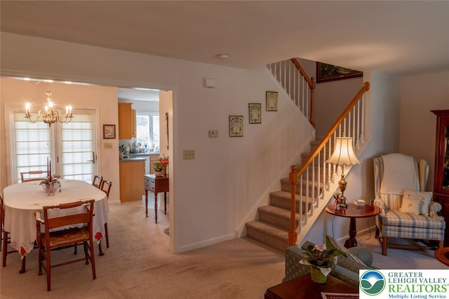 104 Garden Ct, Emmaus Boro, PA 18049 - dining area featuring a chandelier, stairs, and light carpet