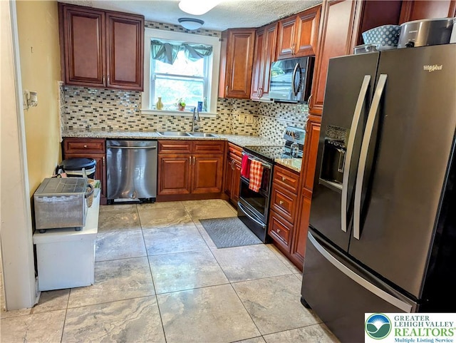 2816 W Columbia St, South Whitehall Twp, PA 18104 - kitchen featuring appliances with stainless steel finishes, backsplash, light stone countertops, and light tile patterned flooring