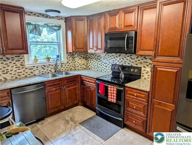 2816 W Columbia St, South Whitehall Twp, PA 18104 - kitchen featuring stainless steel appliances, decorative backsplash, light tile patterned floors, light stone countertops, and brown cabinetry