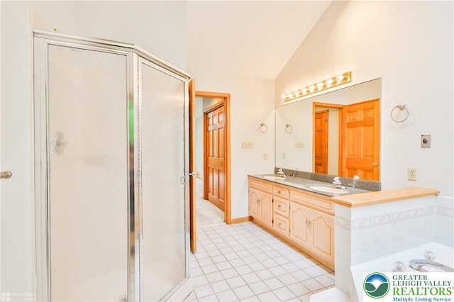 6242 Domarray St, Upper Saucon Twp, PA 18036 - bathroom featuring a shower stall, vaulted ceiling, double vanity, a bath, and tile patterned flooring