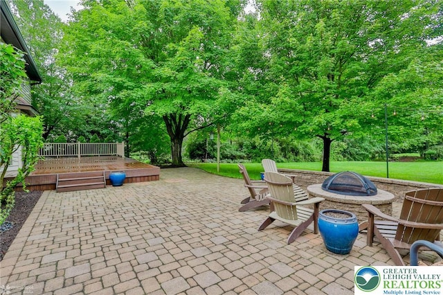 6242 Domarray St, Upper Saucon Twp, PA 18036 - view of patio with a fire pit, a wooden deck, and view of scattered trees