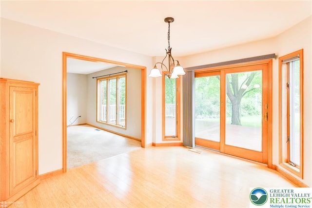 6242 Domarray St, Upper Saucon Twp, PA 18036 - unfurnished dining area with a chandelier, healthy amount of natural light, and light wood-style flooring