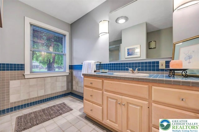 938 Meadow Cir, Bethlehem City, PA 18017 - full bathroom with tile walls, vanity, tile patterned floors, and wainscoting