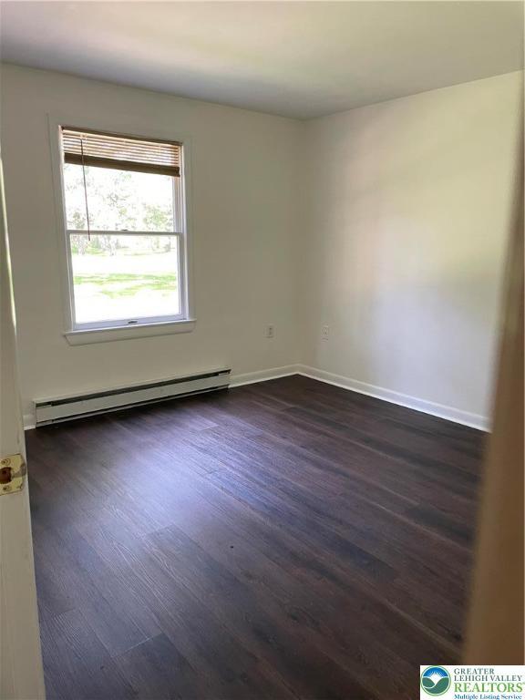 849 Weir Lake Rd, Chestnuthill Twp, PA 18058 - empty room with a baseboard heating unit and dark wood-style flooring
