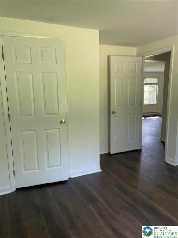 849 Weir Lake Rd, Chestnuthill Twp, PA 18058 - unfurnished bedroom with dark wood finished floors and a baseboard heating unit