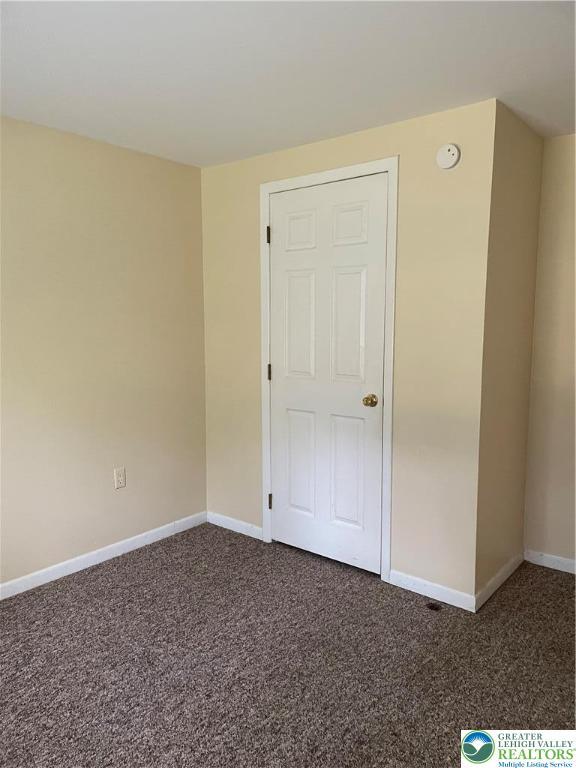 849 Weir Lake Rd, Chestnuthill Twp, PA 18058 - unfurnished room with dark carpet and a smoke detector