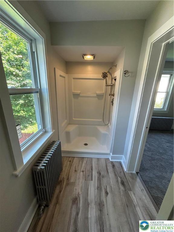 230 White St, Lehighton Boro, PA 18235 - full bath featuring radiator heating unit, a shower stall, and wood finished floors