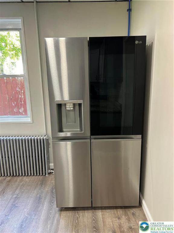230 White St, Lehighton Boro, PA 18235 - kitchen view of radiator heating unit, stainless steel refrigerator with ice dispenser, and light wood finished floors