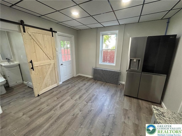 230 White St, Lehighton Boro, PA 18235 - entryway with radiator, a barn door, wood finished floors, a baseboard radiator, and a paneled ceiling