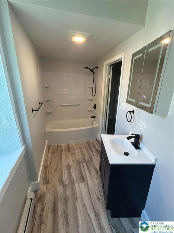 230 White St, Lehighton Boro, PA 18235 - bathroom with a baseboard radiator, vanity, wood finished floors, and shower / bath combination
