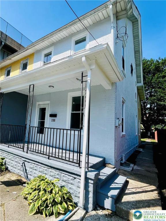230 White St, Lehighton Boro, PA 18235 - view of front of house with a porch and brick siding