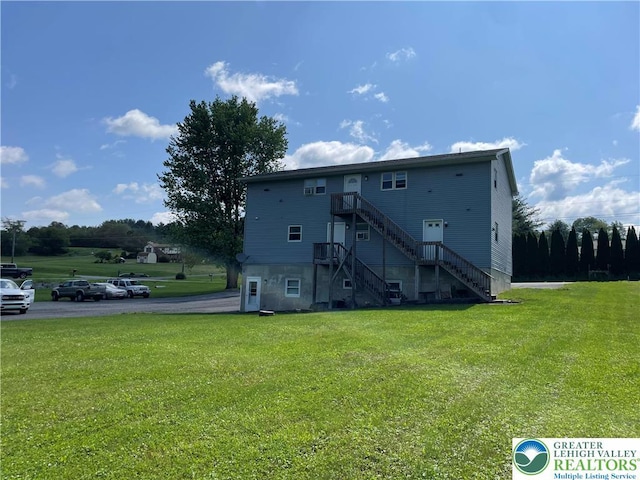 1295 Bunny Ln, Chestnuthill Twp, PA 18322 - rear view of house featuring stairs and a lawn