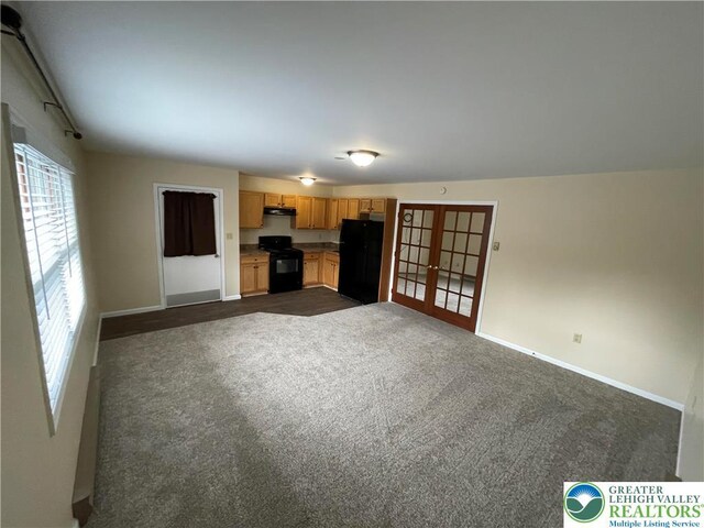 1295 Bunny Ln, Chestnuthill Twp, PA 18322 - unfurnished living room with french doors and dark colored carpet