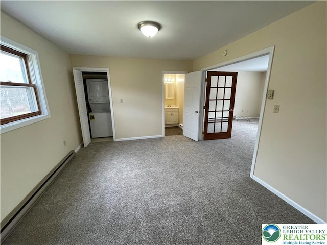 1295 Bunny Ln, Chestnuthill Twp, PA 18322 - unfurnished bedroom featuring a baseboard heating unit, dark colored carpet, and connected bathroom