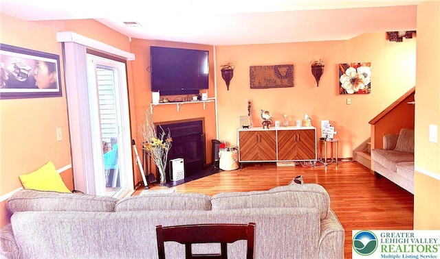 3353 Windermere Dr, Lehman Twp, PA 18324 - living room with a fireplace with flush hearth, wood finished floors, and stairs