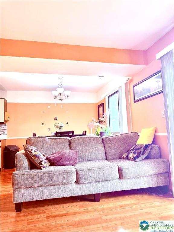 3353 Windermere Dr, Lehman Twp, PA 18324 - living area featuring a chandelier and light wood finished floors