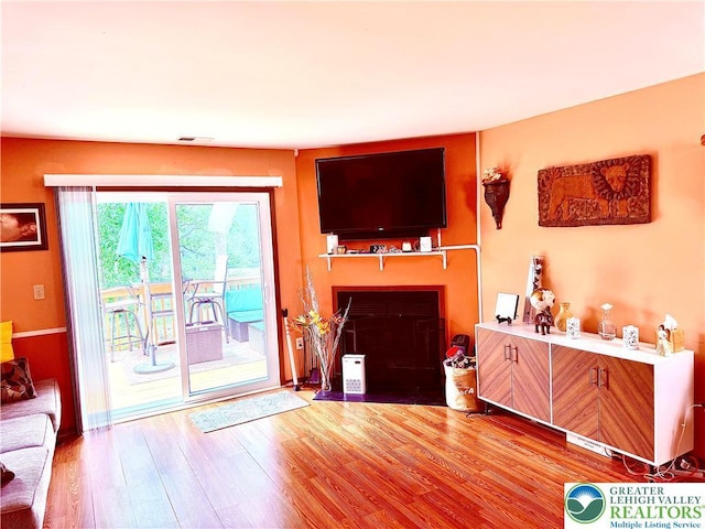 3353 Windermere Dr, Lehman Twp, PA 18324 - living area featuring a fireplace with flush hearth and wood finished floors