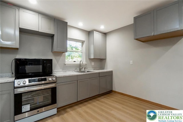 226 Fern St, Jim Thorpe Boro, PA 18229 - kitchen featuring gray cabinetry, electric stove, black microwave, light wood-type flooring, and recessed lighting