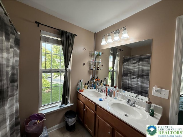 1499 Artisan Ct, Upper Macungie Twp, PA 18031 - full bath with double vanity, tile patterned flooring, healthy amount of natural light, and curtained shower