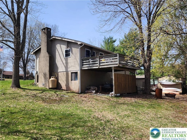 1007 Calypso, Wayne, PA 18436 - back of house with a chimney, a wooden deck, and a yard