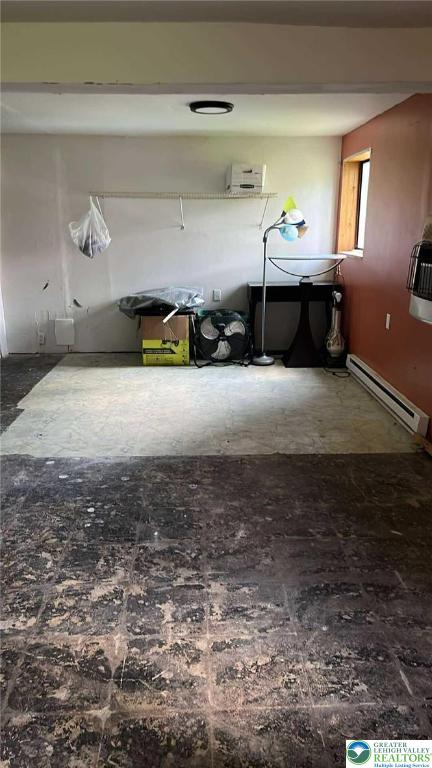 1007 Calypso, Wayne, PA 18436 - garage featuring a baseboard radiator and an AC wall unit