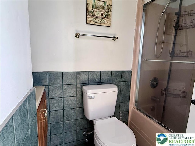 193 Canterbury Rd, Lehman Twp, PA 18324 - bathroom featuring tile walls, wainscoting, shower / bath combination with glass door, and vanity