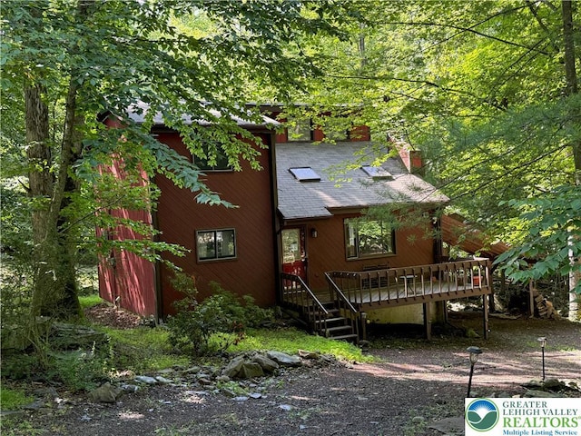 193 Canterbury Rd, Lehman Twp, PA 18324 - view of front facade with a chimney, a shingled roof, and a wooden deck