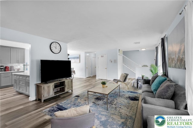 672 Clearview St, Tobyhanna Twp, PA 18334 - living area featuring light wood-style flooring and stairs