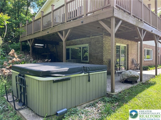 1321 Sheridan Rd, Lower Milford Twp, PA 18036 - back of house featuring a hot tub, brick siding, a deck, and a patio area