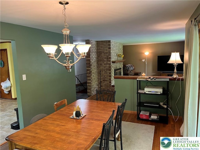 1321 Sheridan Rd, Lower Milford Twp, PA 18036 - dining room with a chandelier, wood finished floors, and a brick fireplace