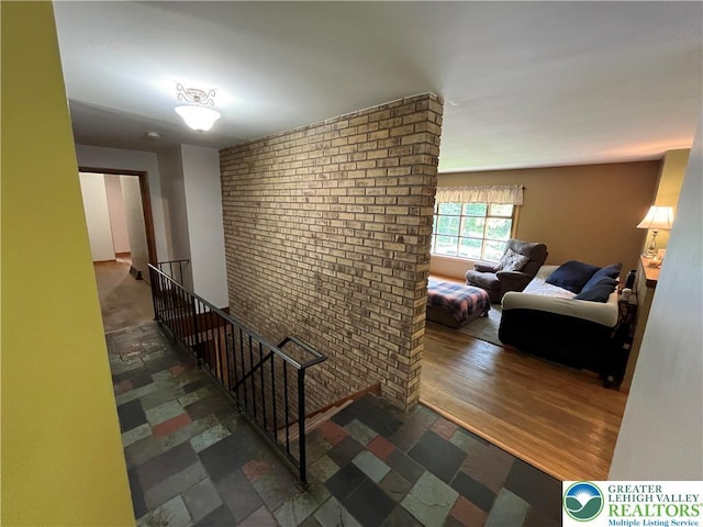 1321 Sheridan Rd, Lower Milford Twp, PA 18036 - hallway featuring an upstairs landing, brick wall, and wood finished floors