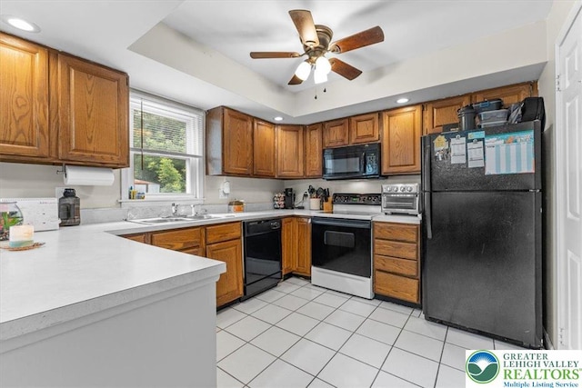 2233 Fox Run, Wilson Boro, PA 18042 - kitchen featuring black appliances, brown cabinets, light countertops, light tile patterned floors, and recessed lighting