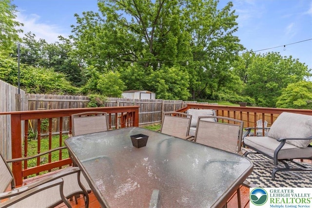 2233 Fox Run, Wilson Boro, PA 18042 - wooden terrace featuring outdoor dining area, a fenced backyard, and view of scattered trees