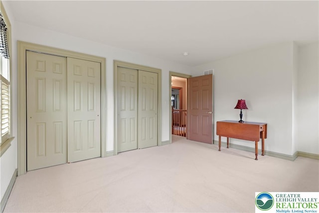 6513 Station Vw, Upper Milford Twp, PA 18092 - unfurnished bedroom featuring two closets and carpet flooring