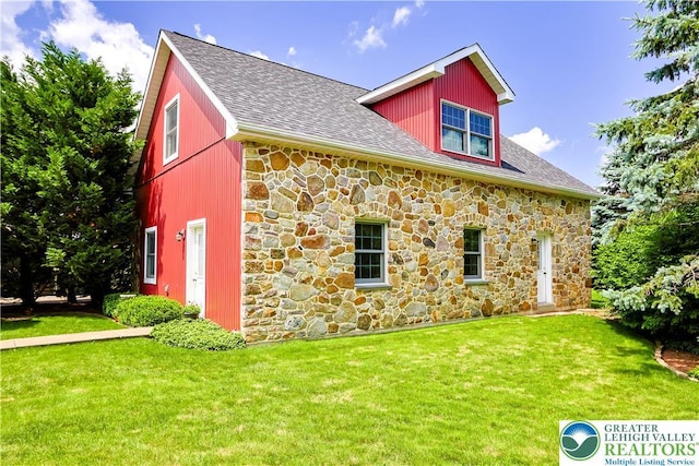 6513 Station Vw, Upper Milford Twp, PA 18092 - view of property exterior with stone siding, a yard, and roof with shingles