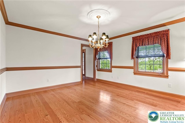 6513 Station Vw, Upper Milford Twp, PA 18092 - empty room featuring a chandelier, wood finished floors, and ornamental molding
