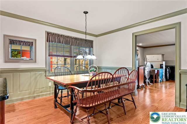 6513 Station Vw, Upper Milford Twp, PA 18092 - dining room with crown molding, wainscoting, a decorative wall, and light wood-style floors