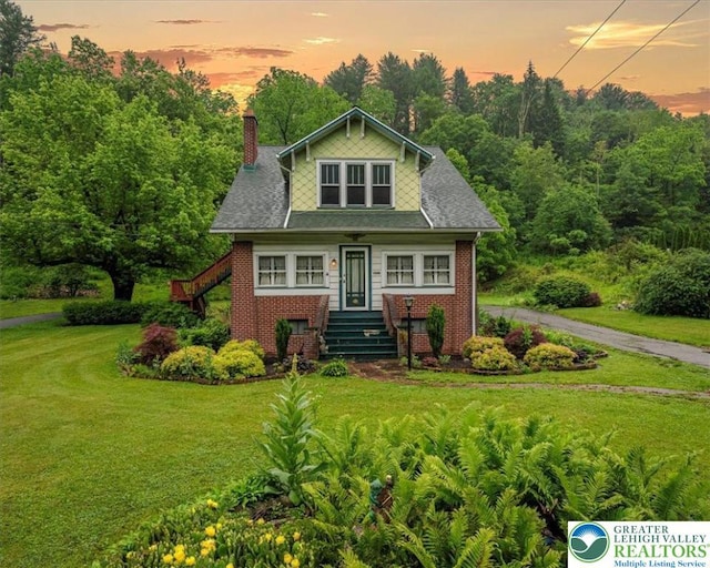 2834 Interchange Rd, Franklin Twp, PA 18235 - view of front of property featuring a front lawn, a chimney, brick siding, and stairs