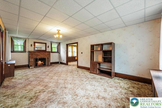 2834 Interchange Rd, Franklin Twp, PA 18235 - unfurnished living room featuring carpet, a drop ceiling, a fireplace, and a chandelier