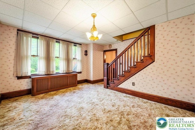 2834 Interchange Rd, Franklin Twp, PA 18235 - unfurnished living room featuring radiator heating unit, wallpapered walls, carpet, stairway, and a chandelier