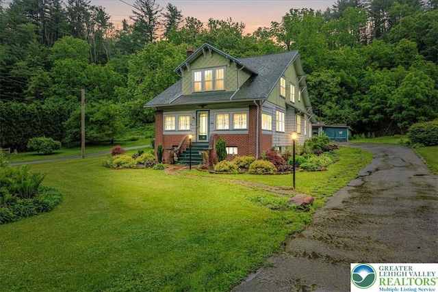 2834 Interchange Rd, Franklin Twp, PA 18235 - view of front of home with brick siding, a front lawn, a chimney, and asphalt driveway