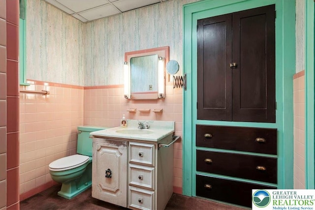 2834 Interchange Rd, Franklin Twp, PA 18235 - bathroom with vanity, a wainscoted wall, and tile walls