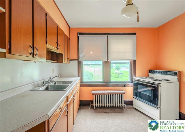 2834 Interchange Rd, Franklin Twp, PA 18235 - kitchen with white range with electric stovetop, radiator heating unit, light countertops, and brown cabinets