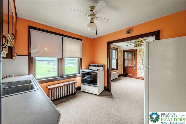 2834 Interchange Rd, Franklin Twp, PA 18235 - kitchen with white appliances, ceiling fan, radiator, and light colored carpet