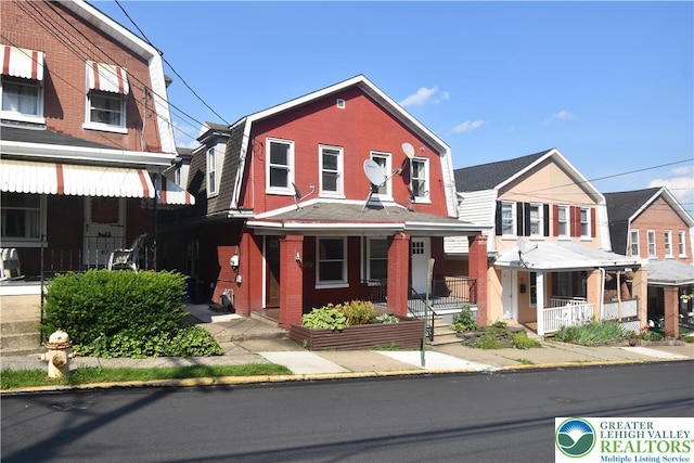 817 Ridge St, Easton, PA 18042 - view of front of house featuring covered porch, a gambrel roof, and brick siding