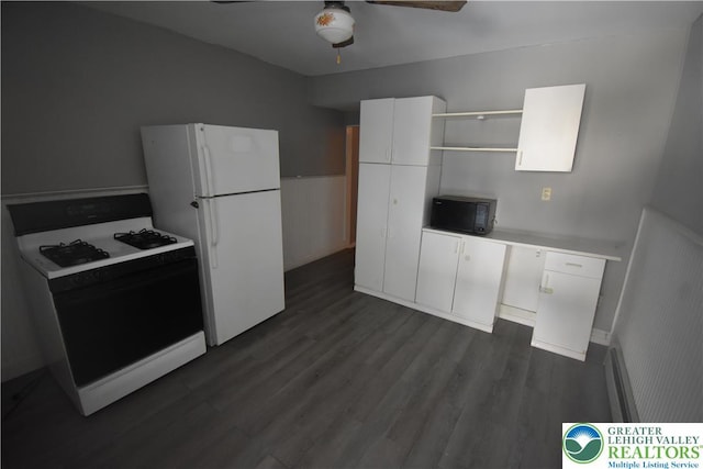 817 Ridge St, Easton, PA 18042 - kitchen with white appliances, open shelves, ceiling fan, dark wood-type flooring, and a wainscoted wall