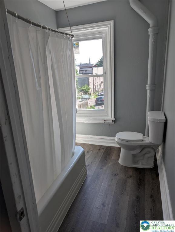 331 N Penn St, Allentown City, PA 18102 - full bathroom with wood finished floors and shower / bath combination with curtain