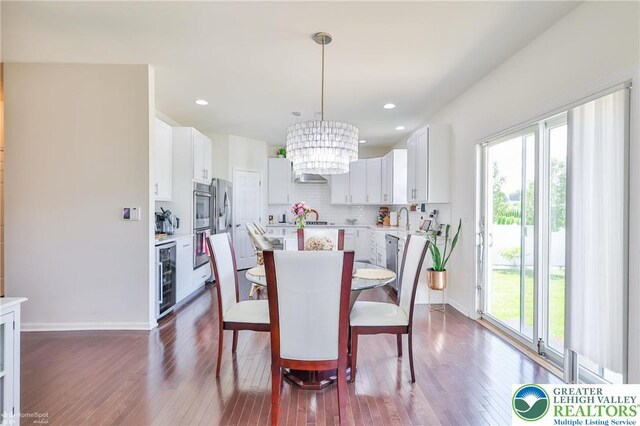 249 Danbury Dr, Upper Nazareth Twp, PA 18064 - dining space featuring a chandelier, dark wood-type flooring, recessed lighting, and wine cooler